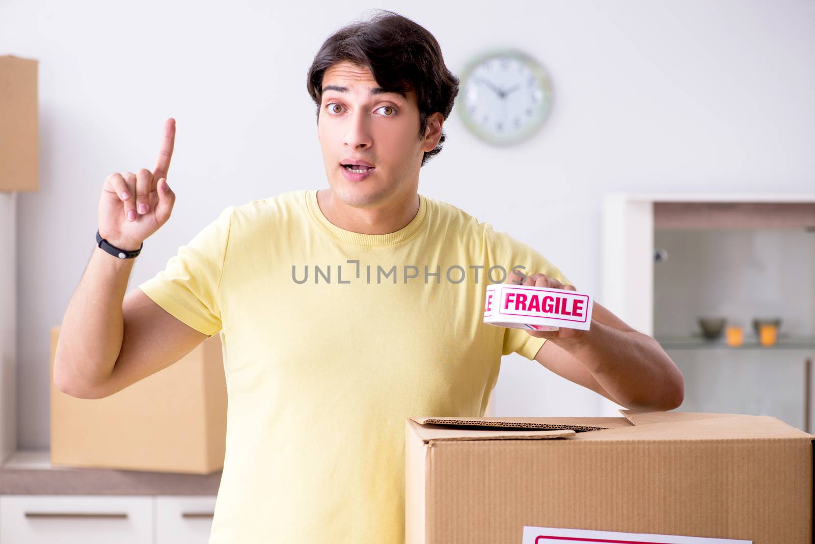 Man moving house and relocating with fragile items