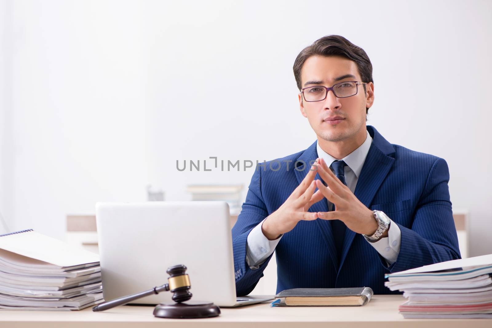 Young handsome judge working in court