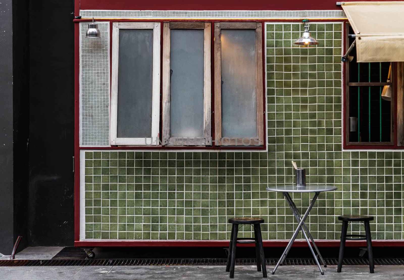 Table and wooden chairs in front of a traditional Chinese food shop. Concept and design front of Chinese retro style. No focus, specifically.