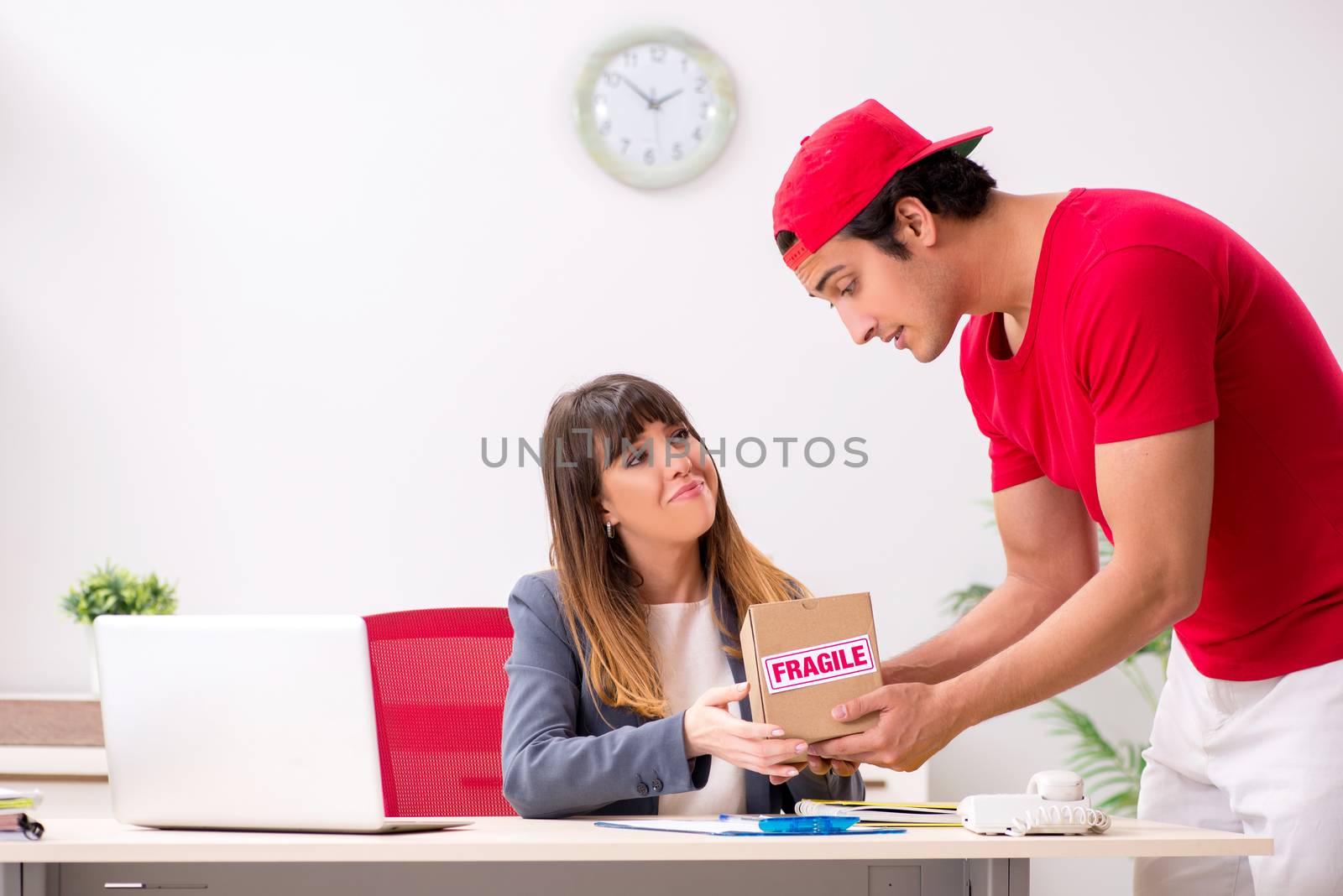 Courier delivering parcel to the office