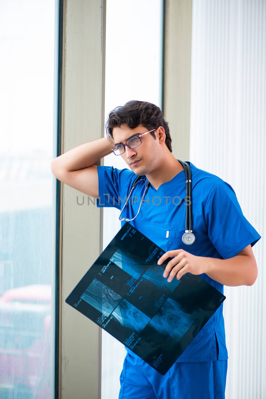 Young handsome doctor working in the hospital 