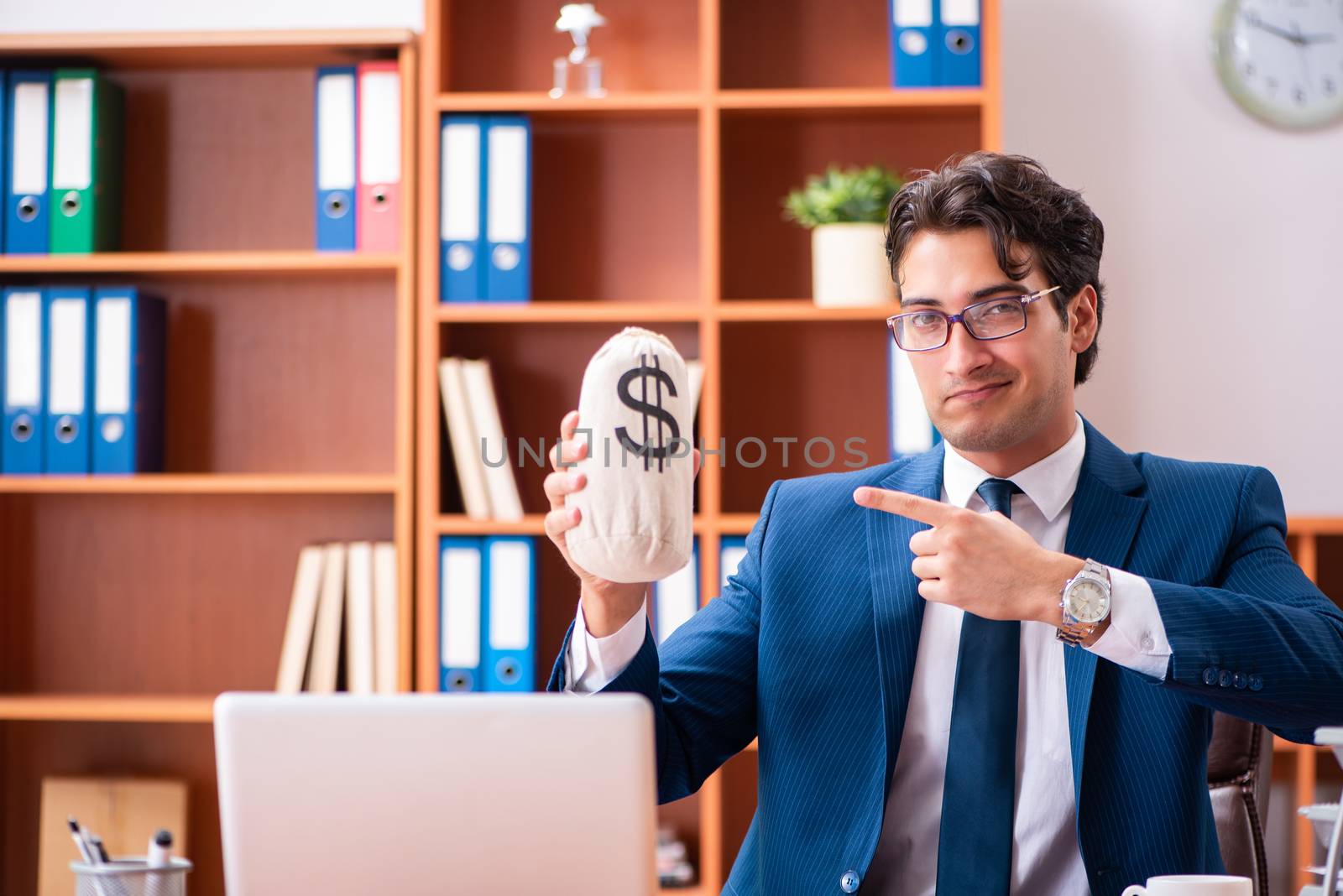 Young handsome businessman working in the office