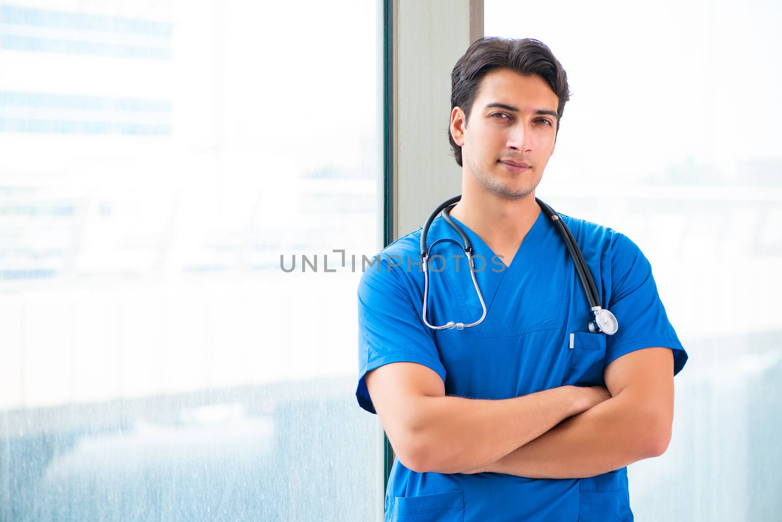 Young handsome doctor working in the hospital 