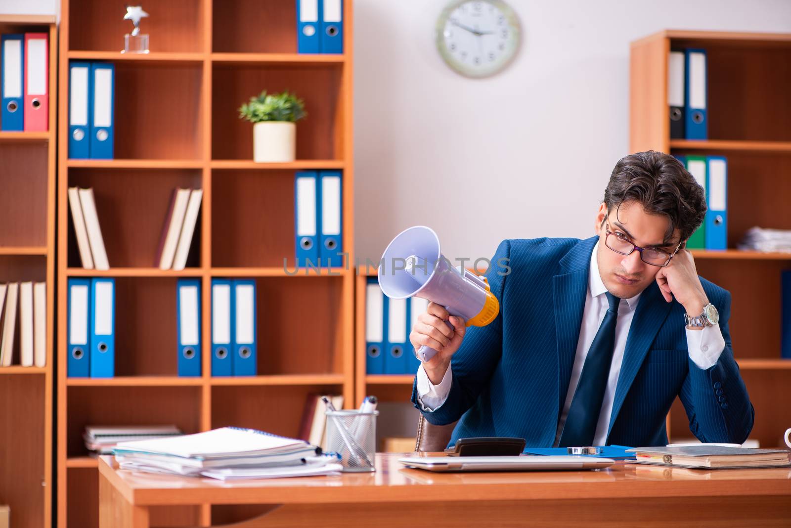 Young handsome businessman working in the office