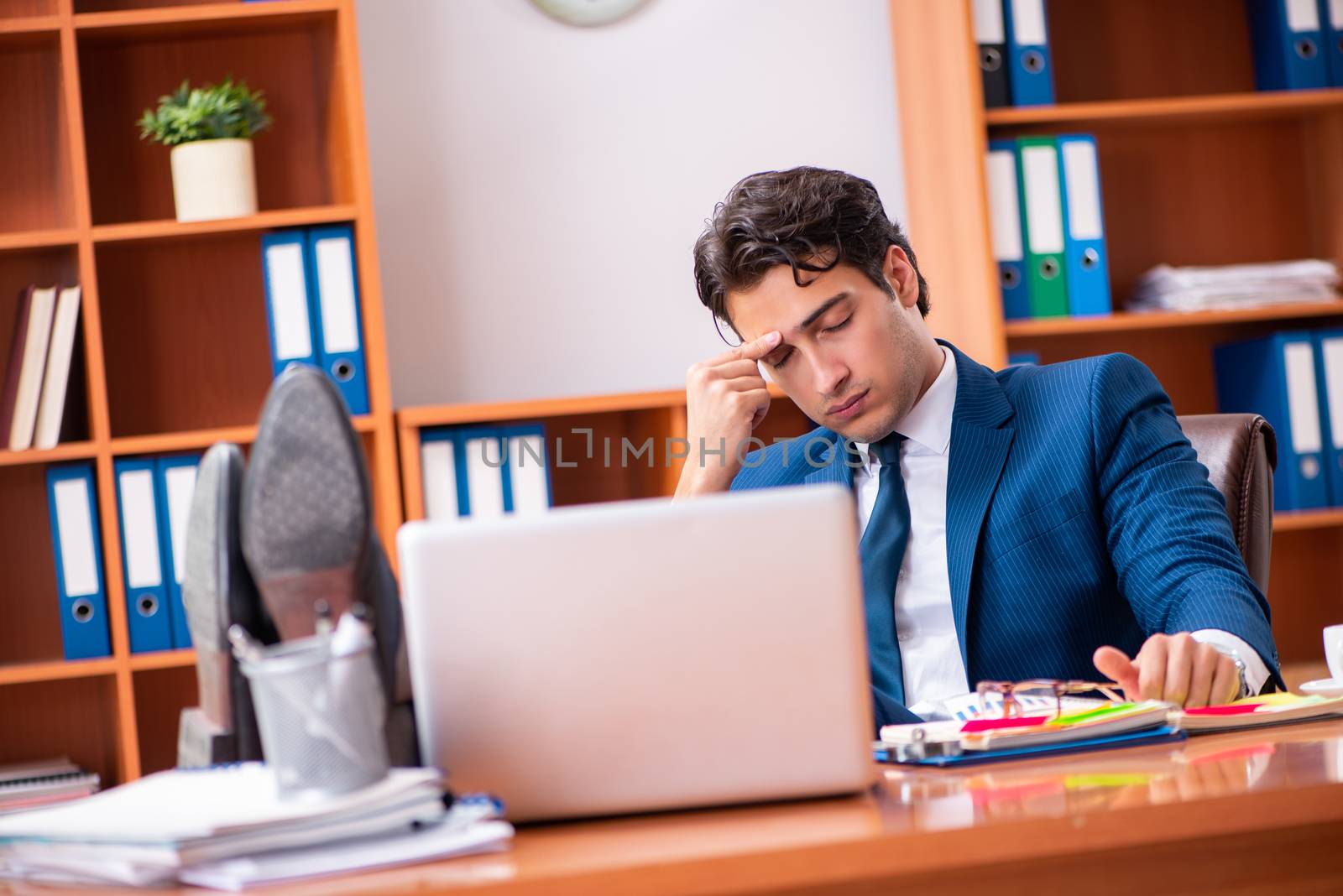 Young handsome businessman working in the office