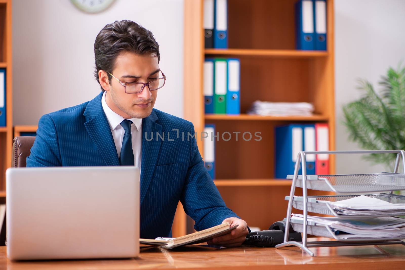 Young handsome businessman working in the office