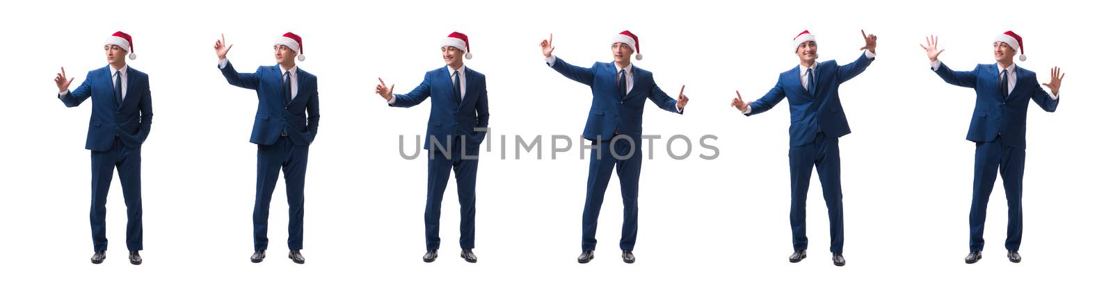 Young busnessman wearing santa hat in christmas concept on white by Elnur