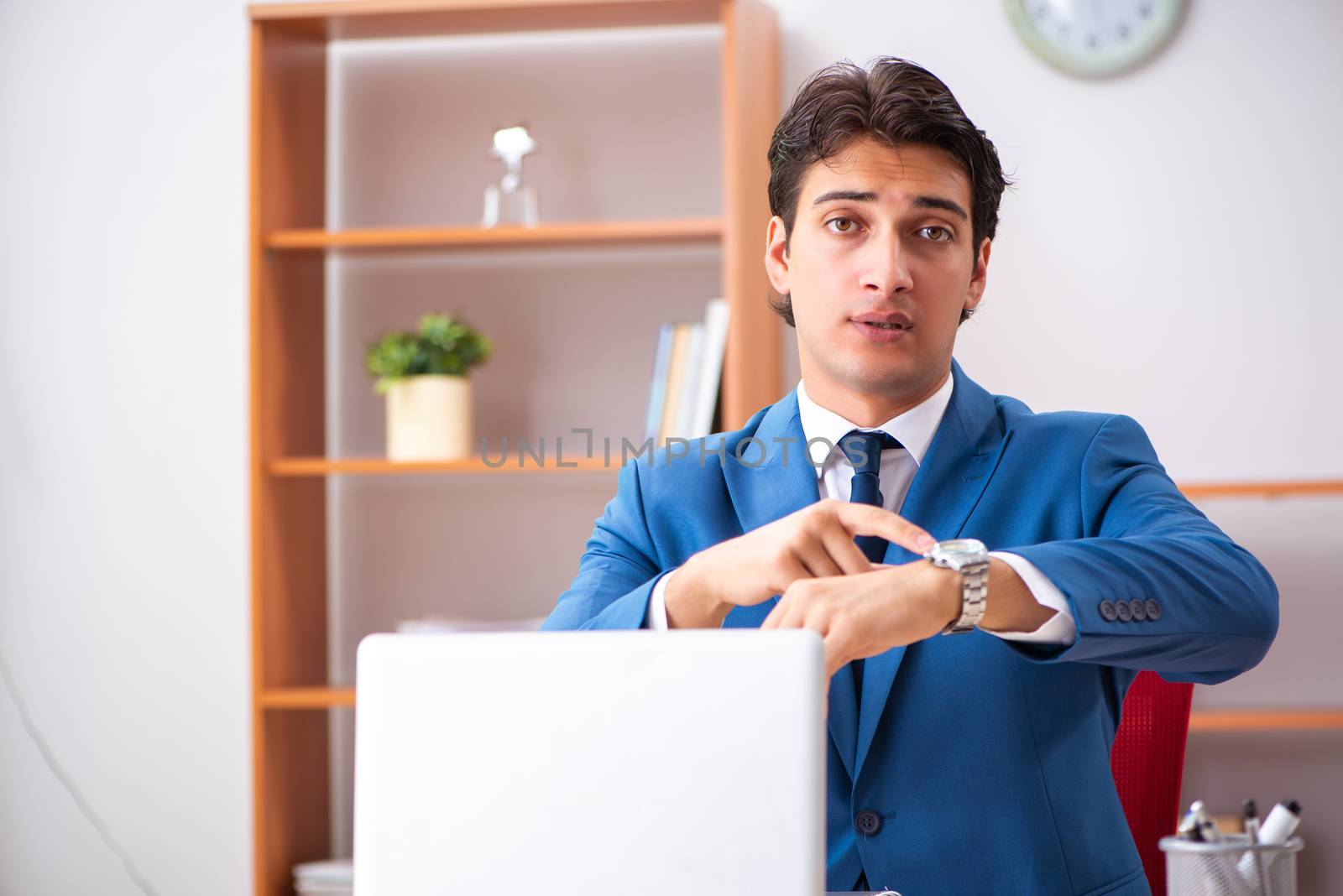 Young handsome businessman working in the office  by Elnur