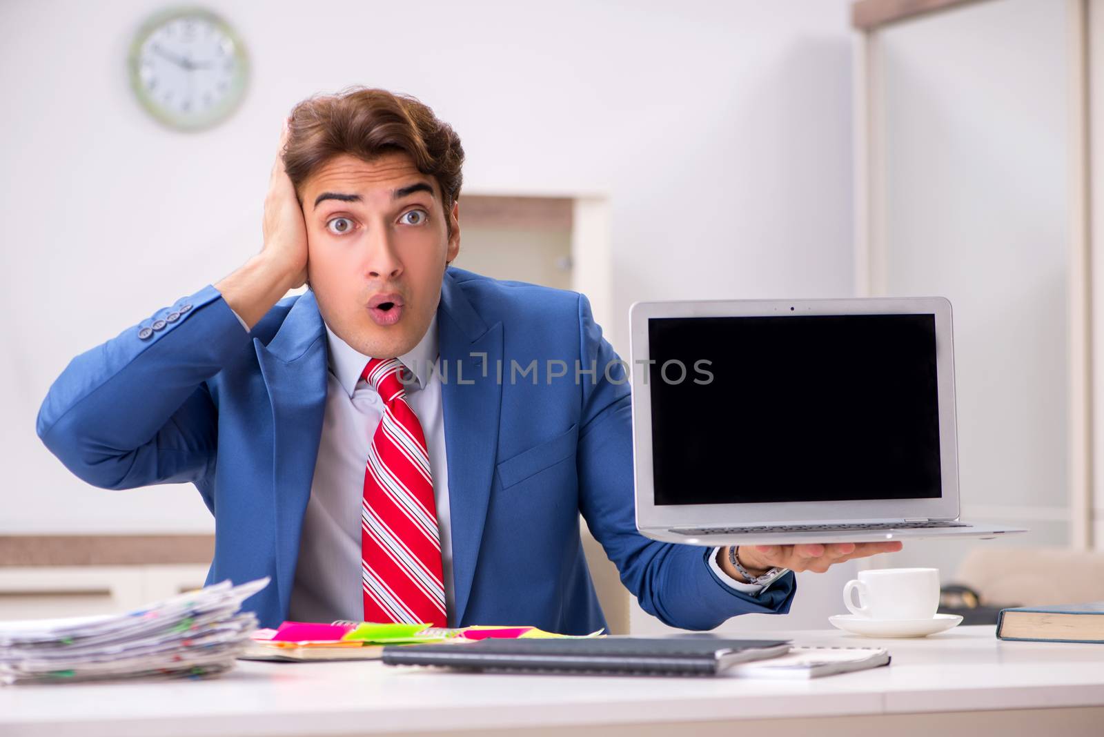 Young attractive businessman working in the office  