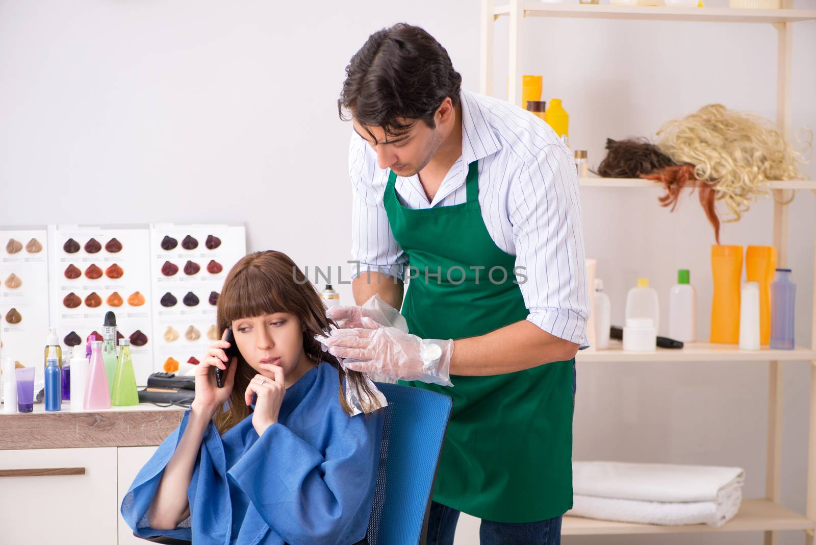 Young woman visiting young handsome barber  by Elnur