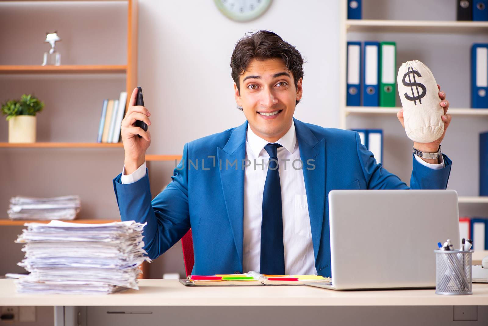 Young handsome businessman working in the office 