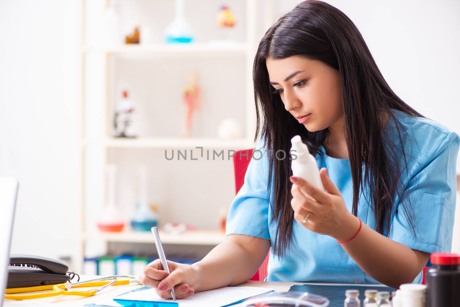 Young beautiful female doctor working in the clinic 