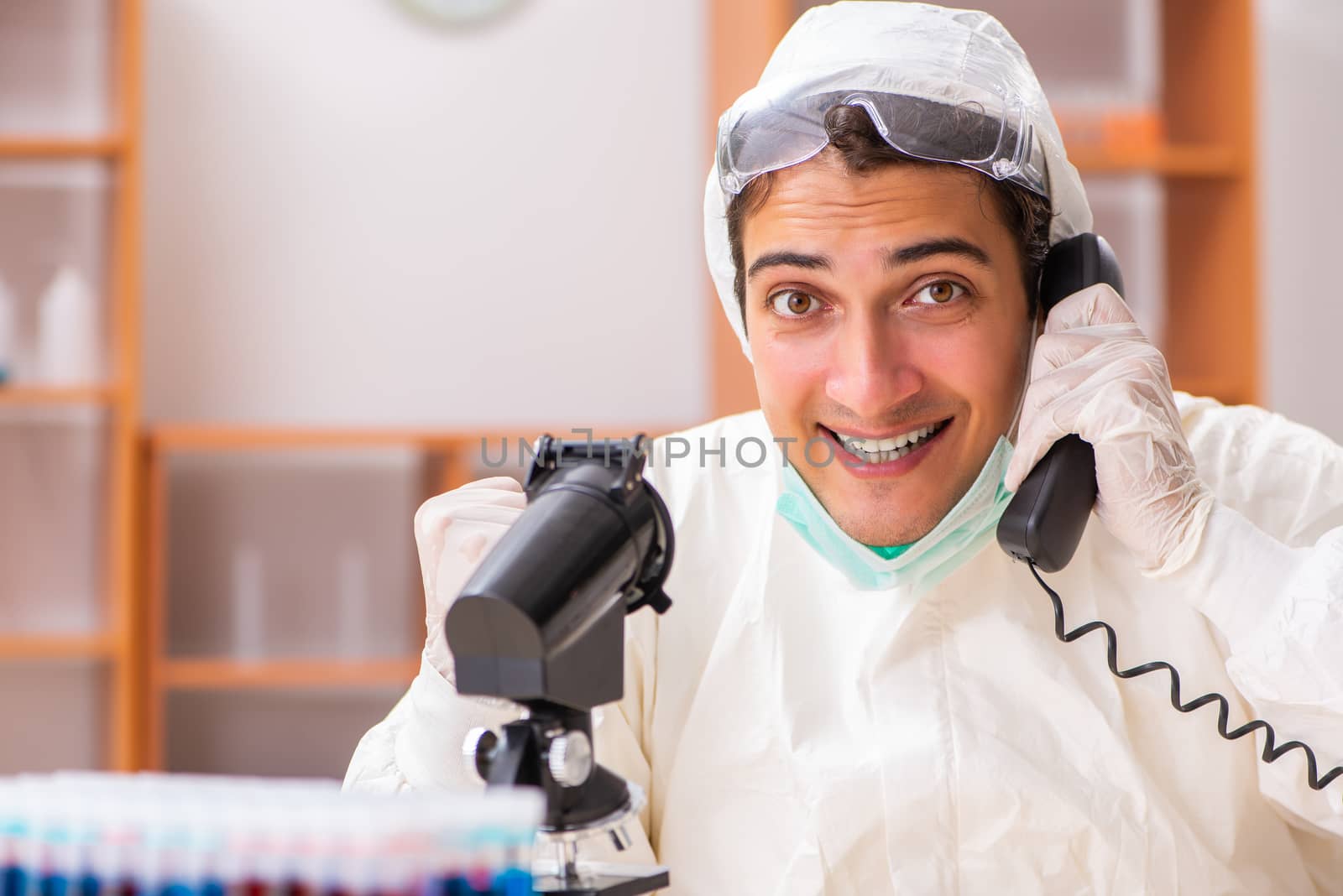 Young biochemist wearing protective suit working in the lab