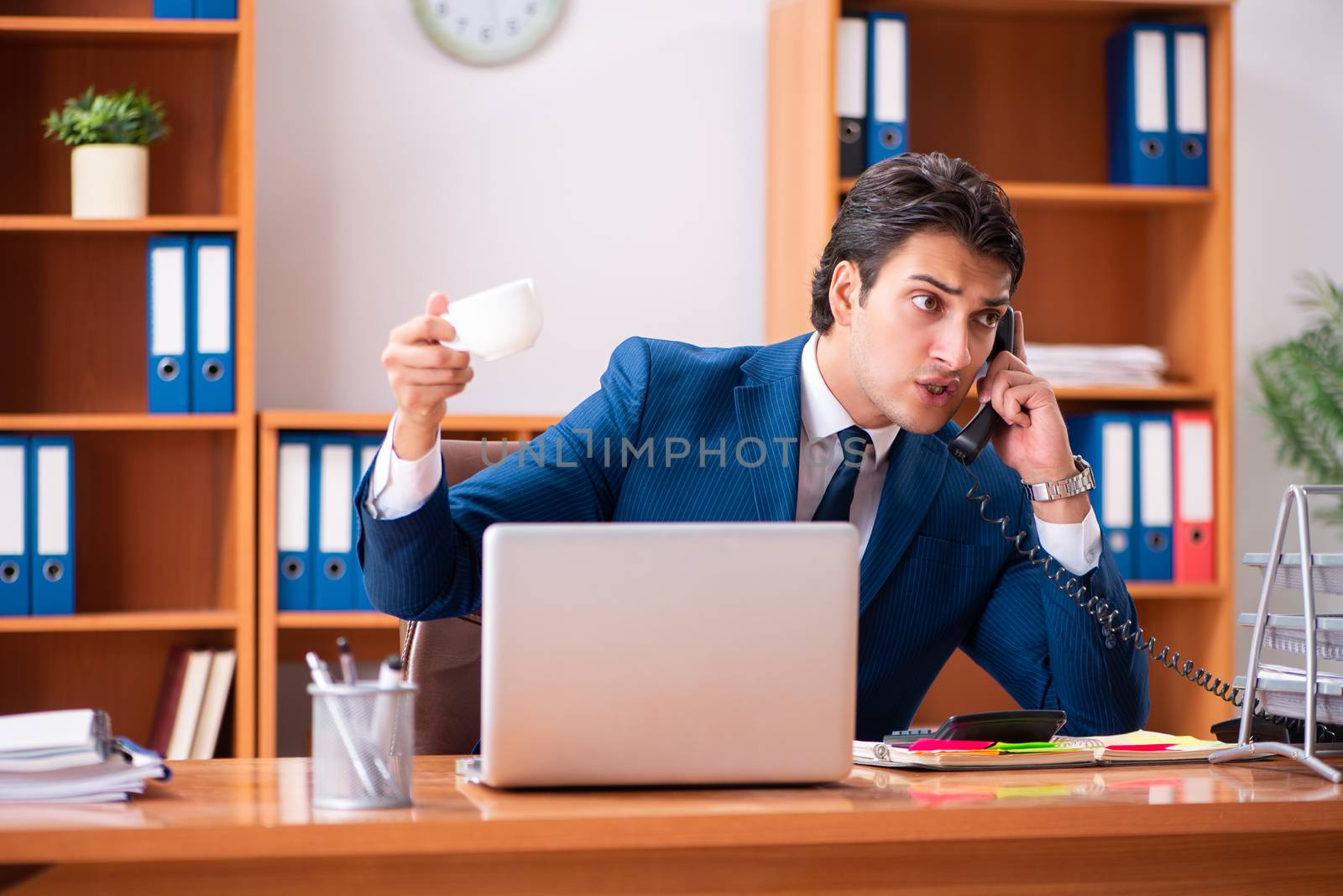 Young handsome businessman working in the office