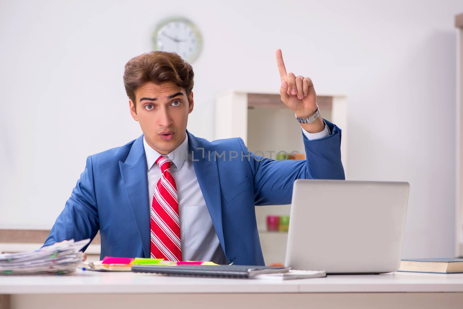 Young attractive businessman working in the office  