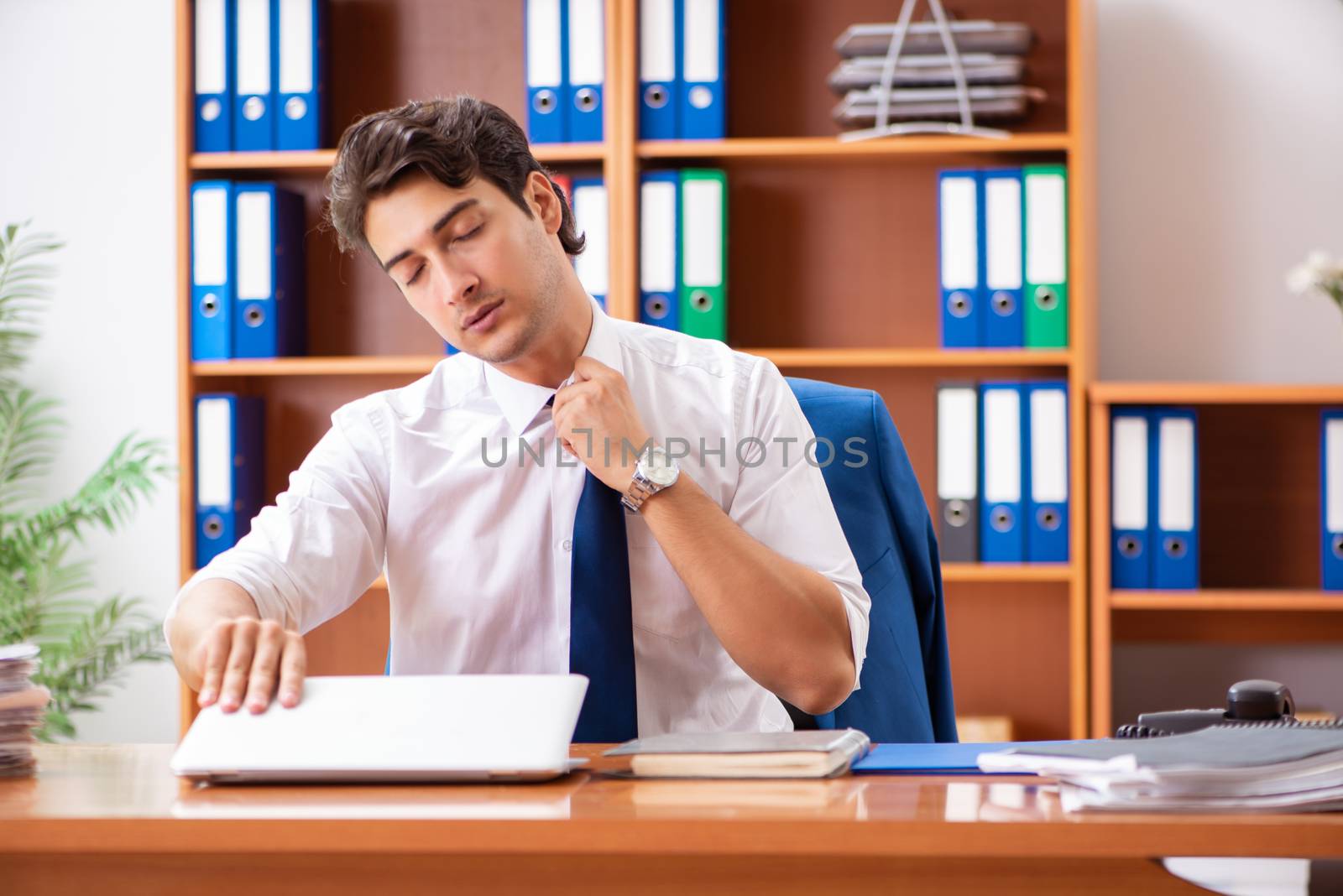 Young employee working in the office by Elnur