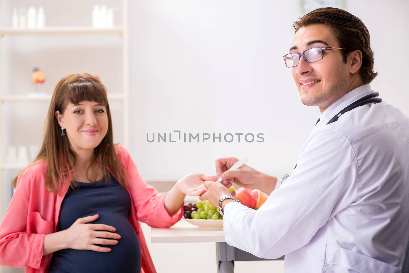 Pregnant woman visiting doctor discussing healthy diet