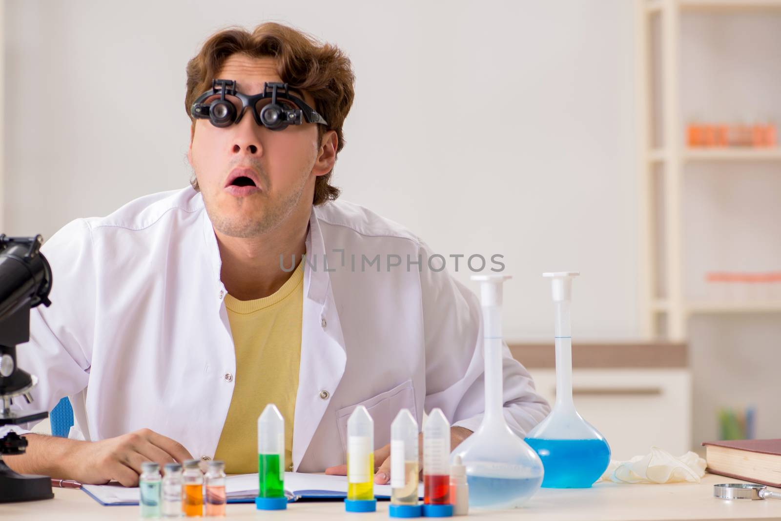 Funny crazy chemist doing experiments and tests