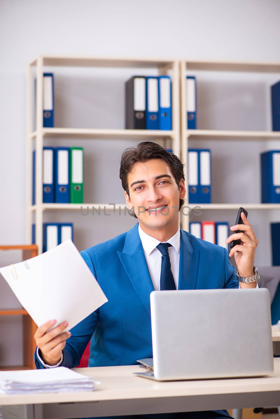 Young handsome businessman working in the office 