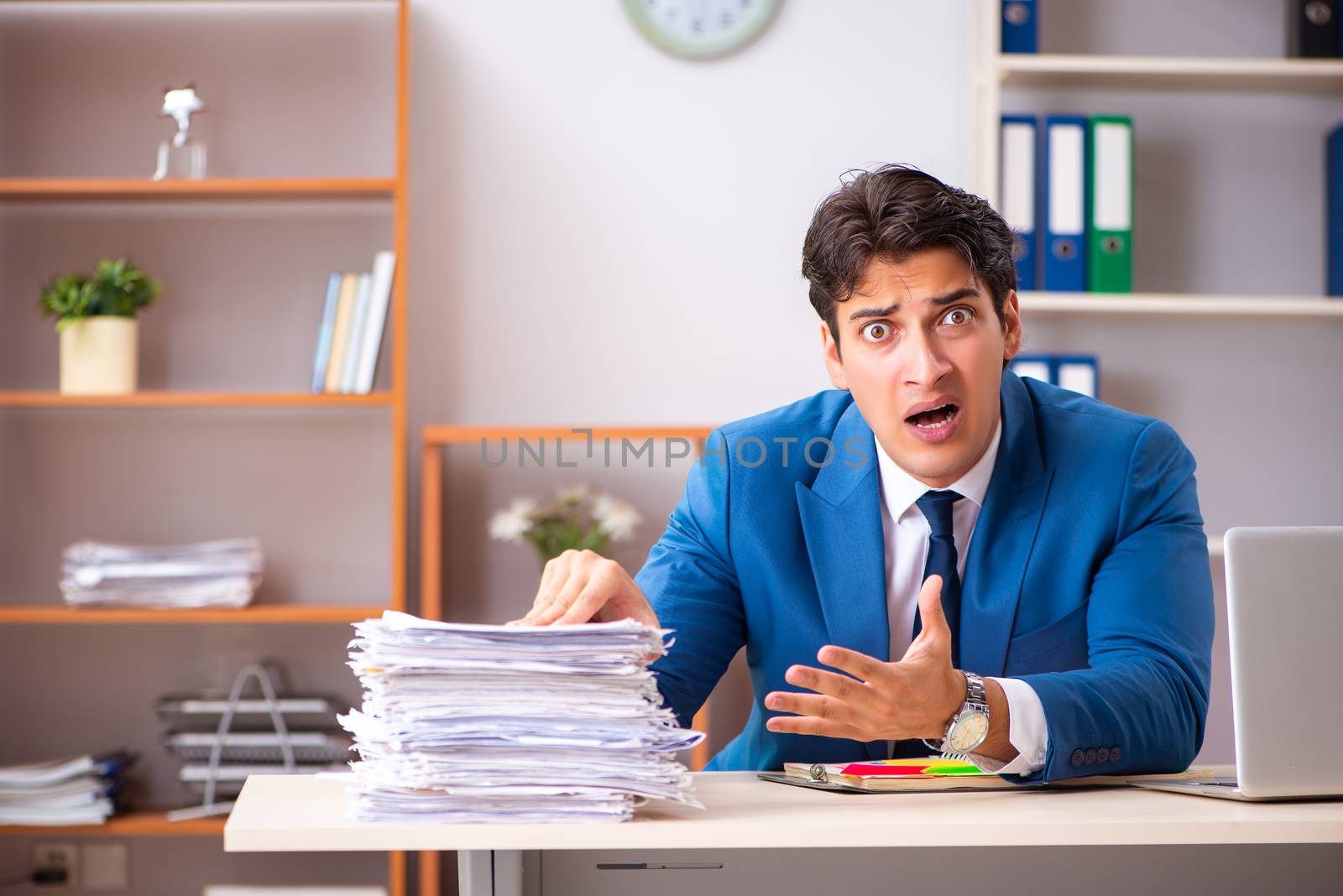 Young handsome businessman working in the office 