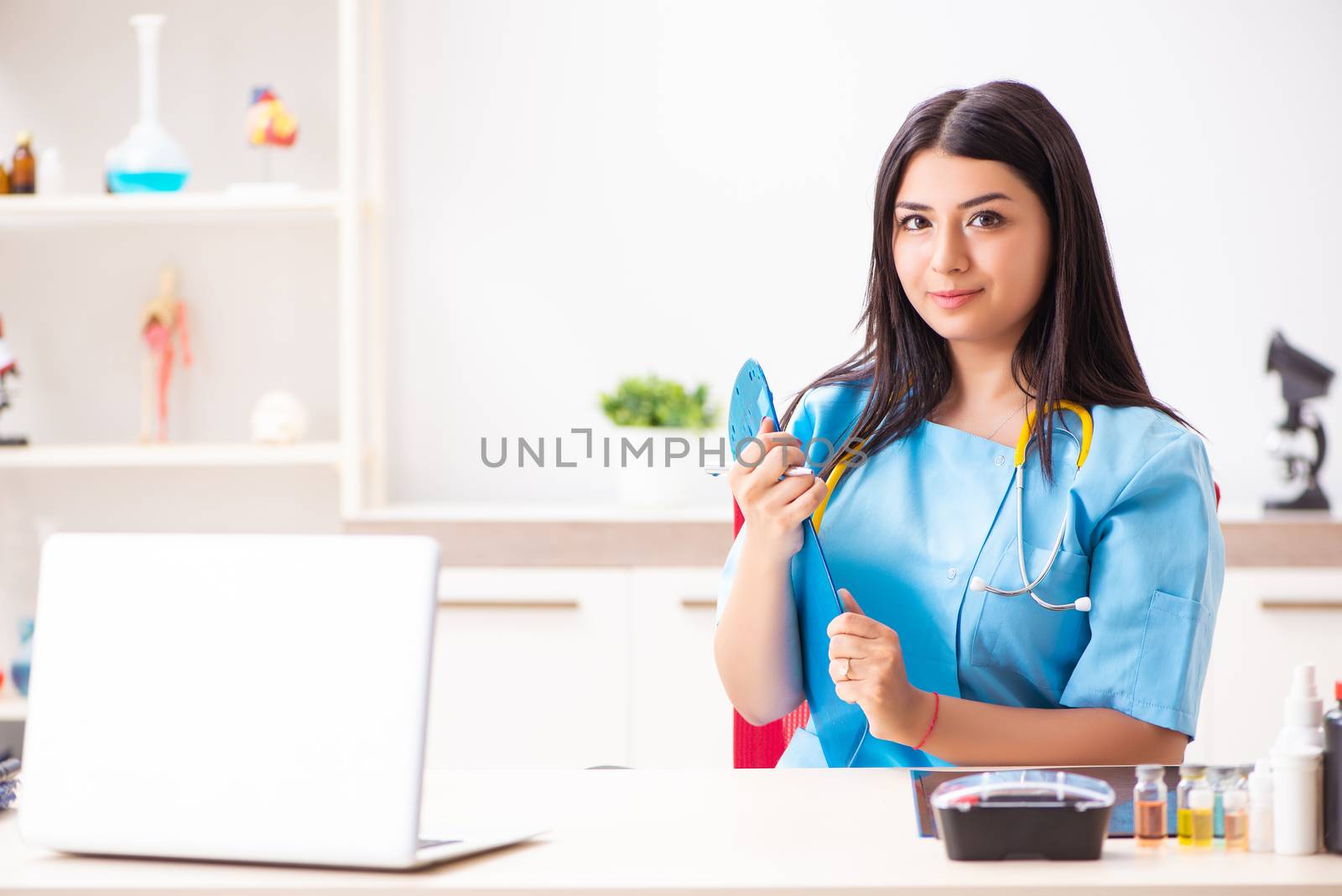 Young beautiful female doctor working in the clinic 