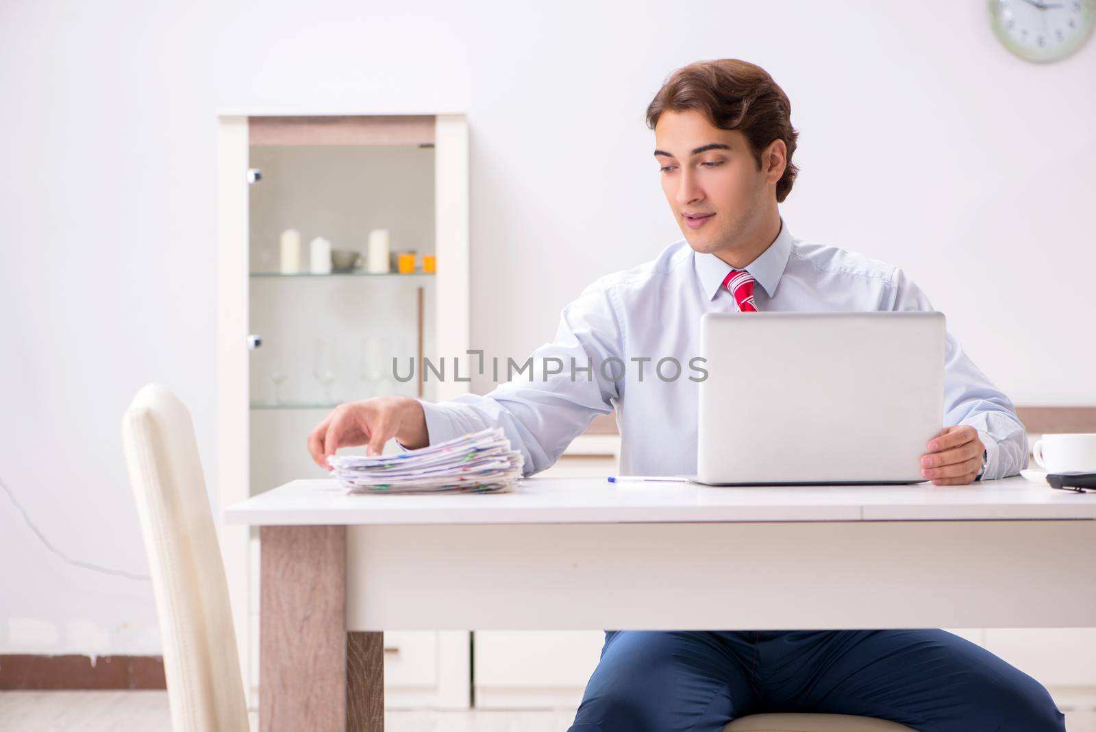 Young attractive businessman working in the office  