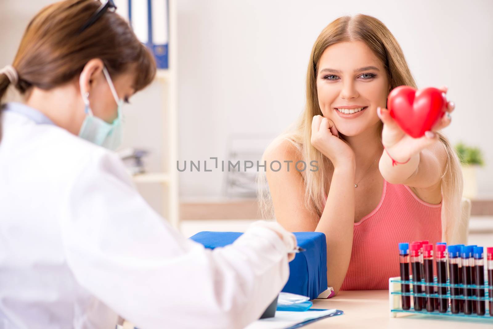 Young beautiful woman during blood test sampling procedure  