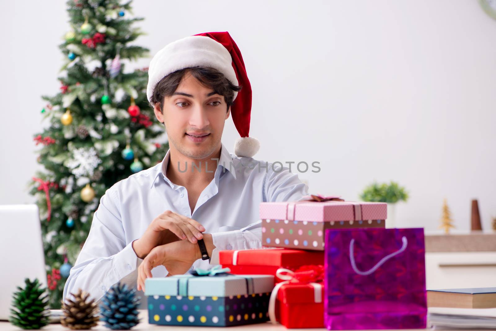 Young employee businessman in office christmas concept by Elnur