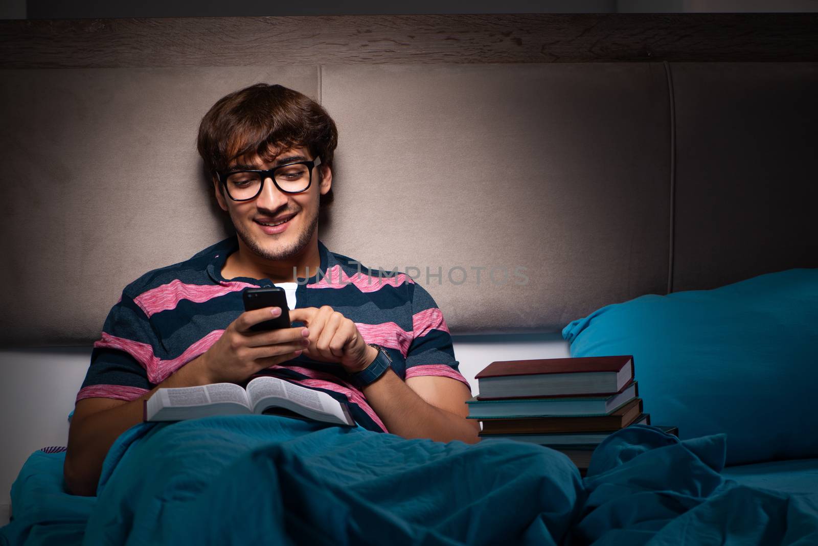 Young student preparing for exams at night at home  by Elnur