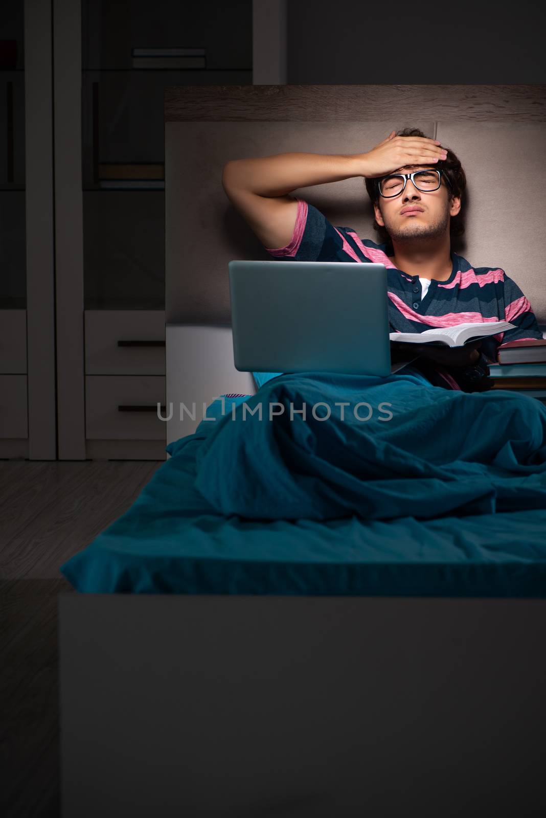Young student preparing for exams at night at home 