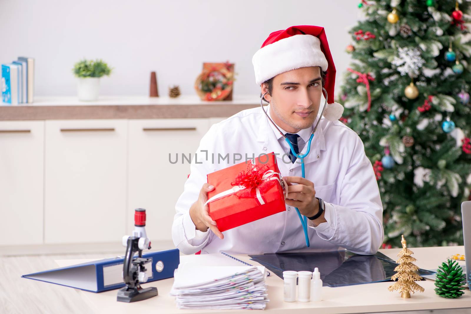 Doctor with gift box in the hospital by Elnur