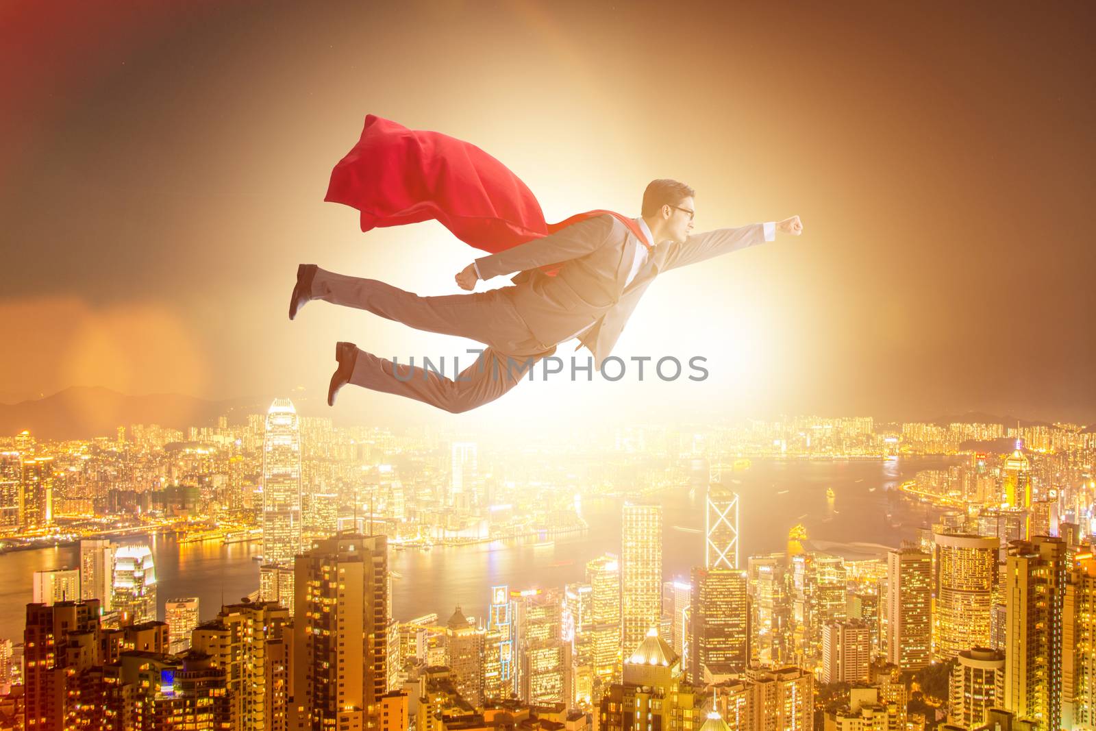 Superhero businessman flying over the city by Elnur