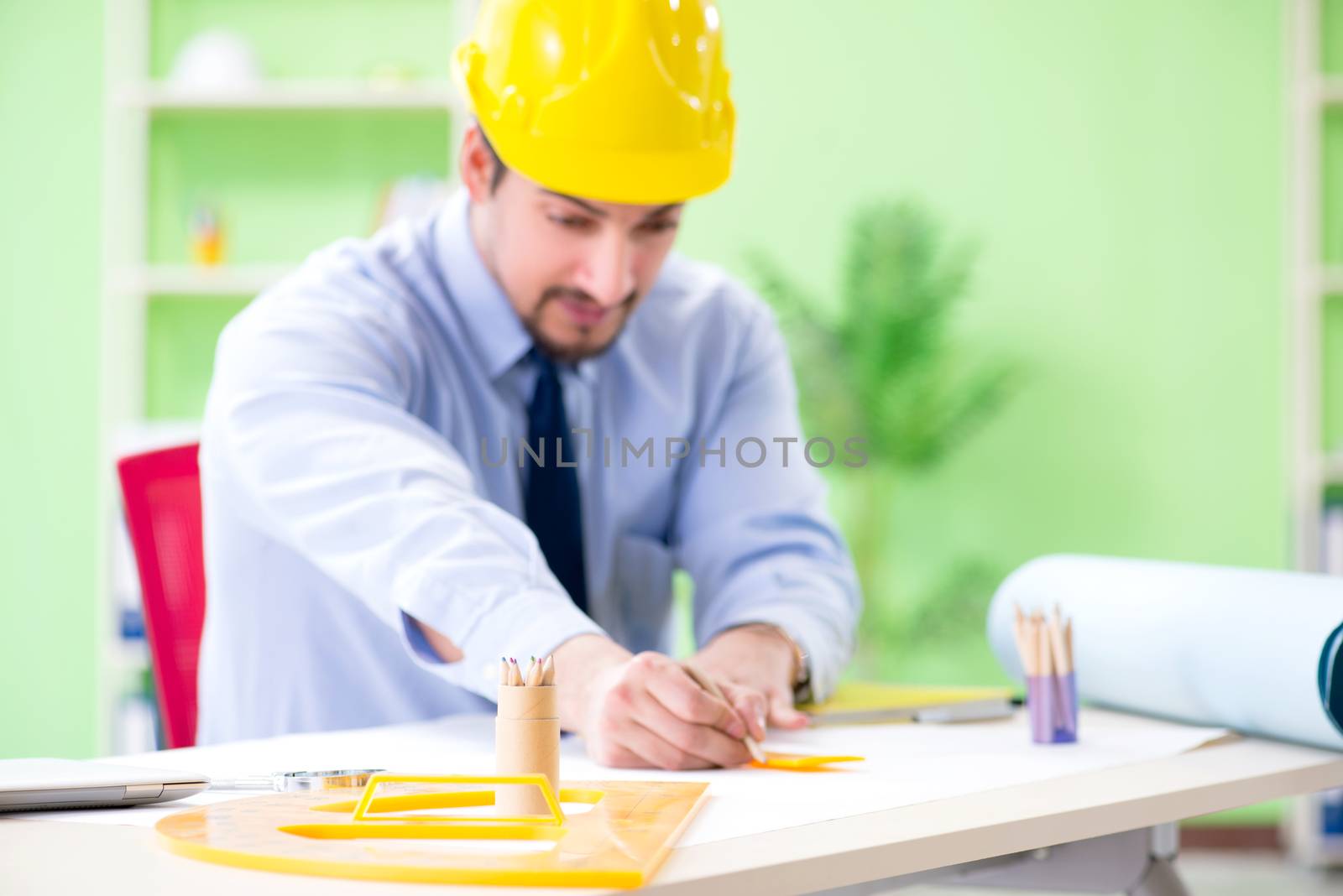 Young male architect working at the project