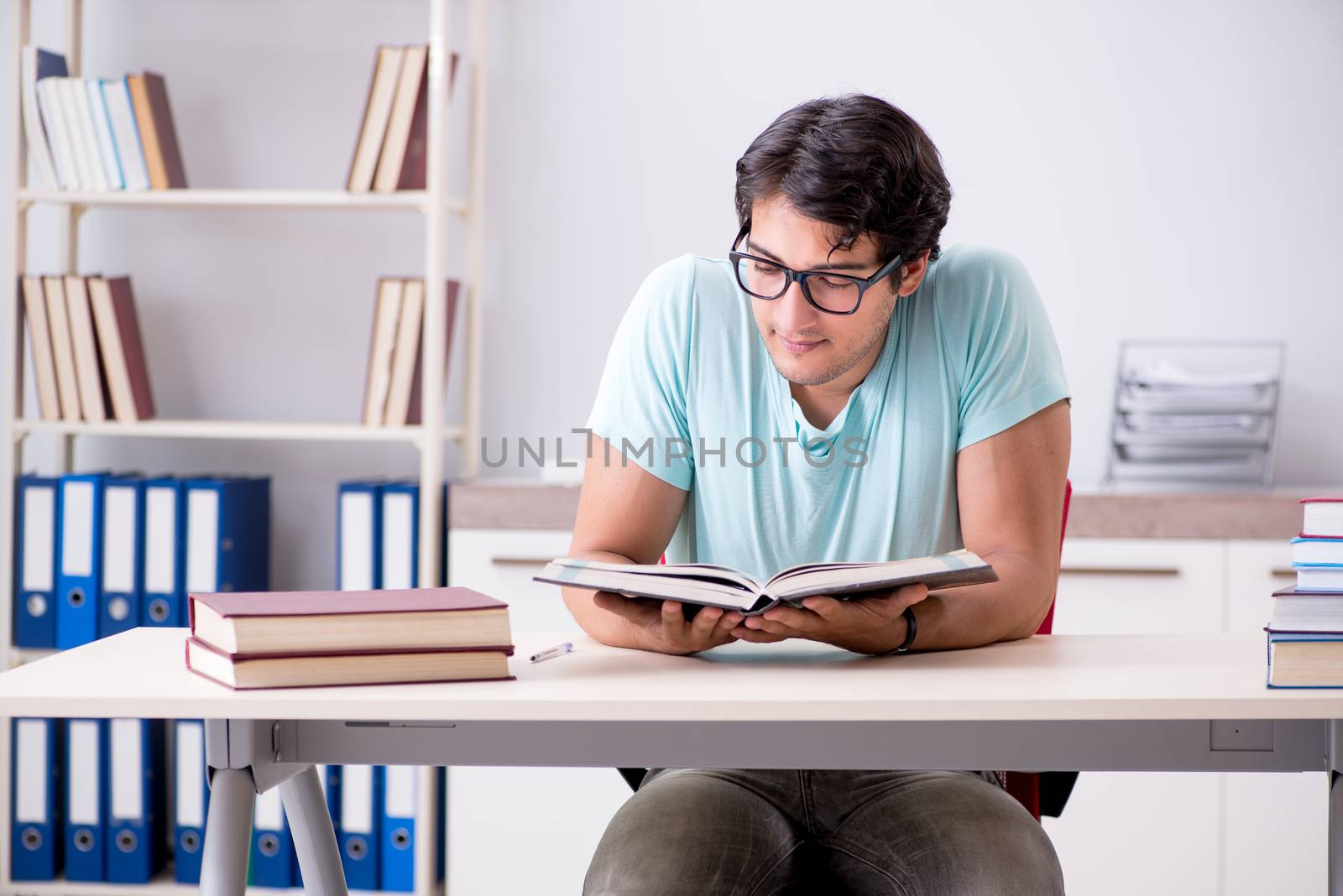 Young handsome student preparing for school exams