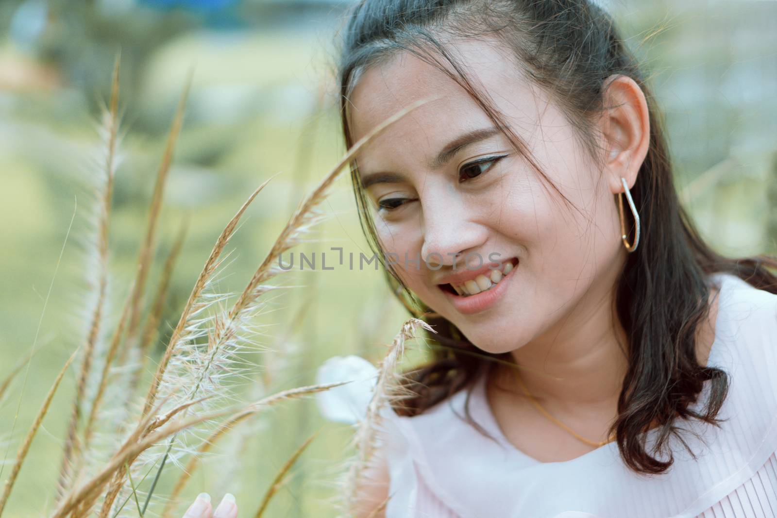 Portrait of asian happy woman smilling with flower garden , Selective focus