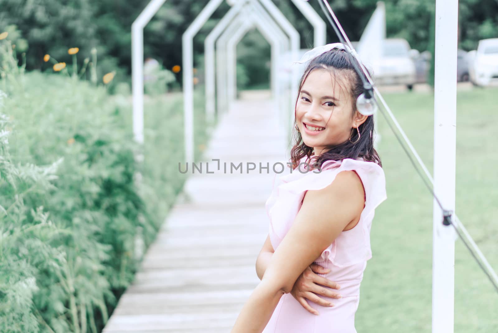 Portrait of asian happy woman smilling with flower garden , Selective focus