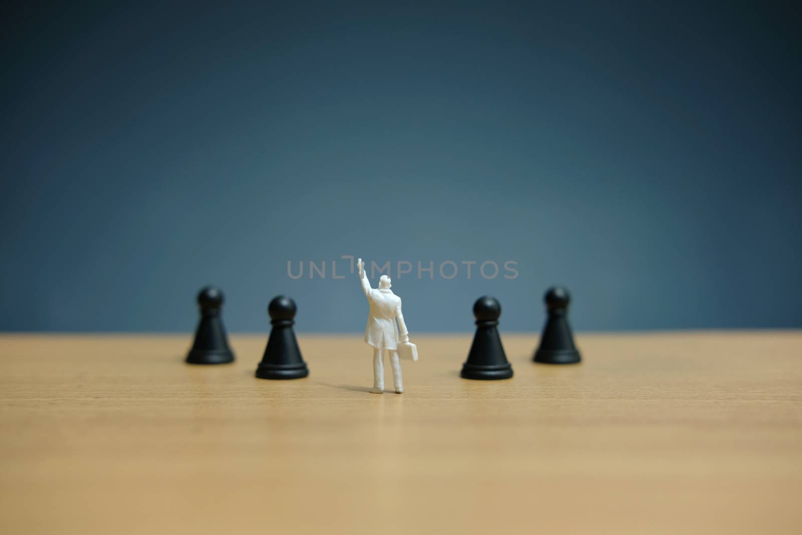 Miniature people strategic concept - businessman standing between losses or dropped pawn