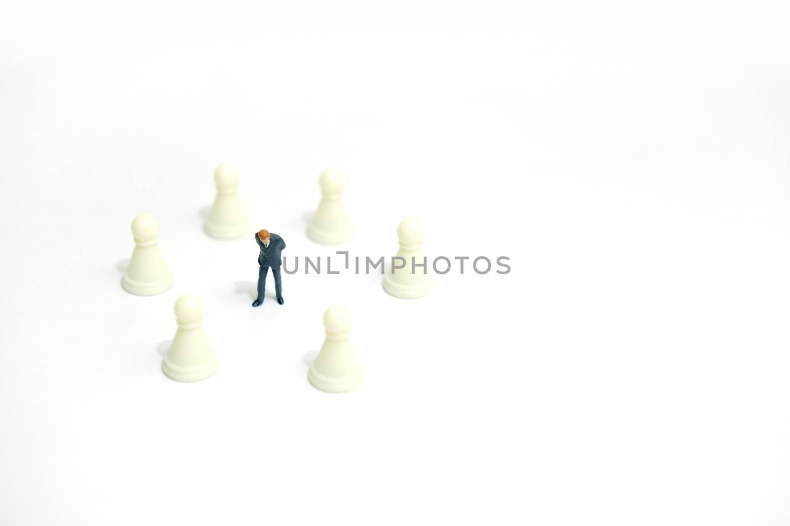 Miniature business strategy concept - businessman standing between chess piece. image photo