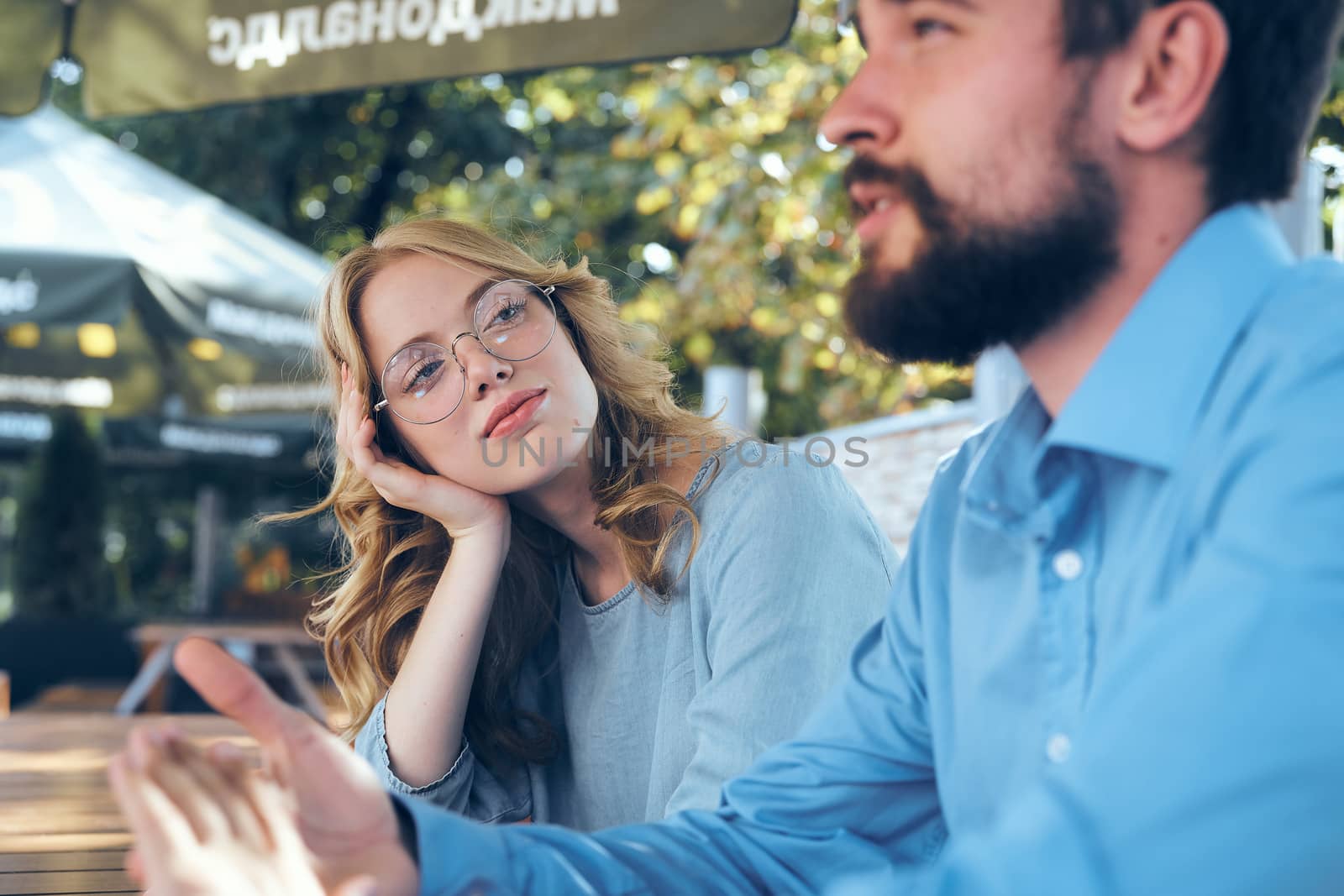 Man and woman communicate in the park outdoors in blue shirts employees friends work. High quality photo