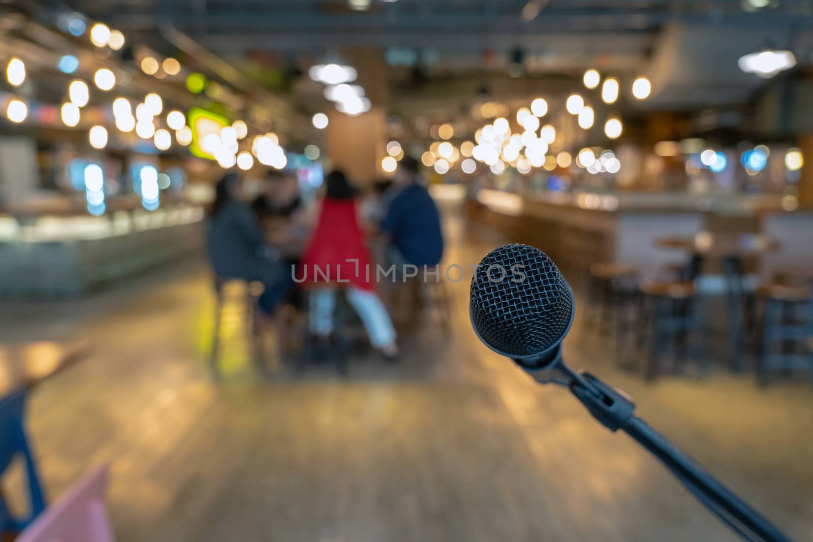 Microphone over the Abstract blurred photo of people group having the meeting in public working space or seminar room, misucal and education with modern lifestyle concept