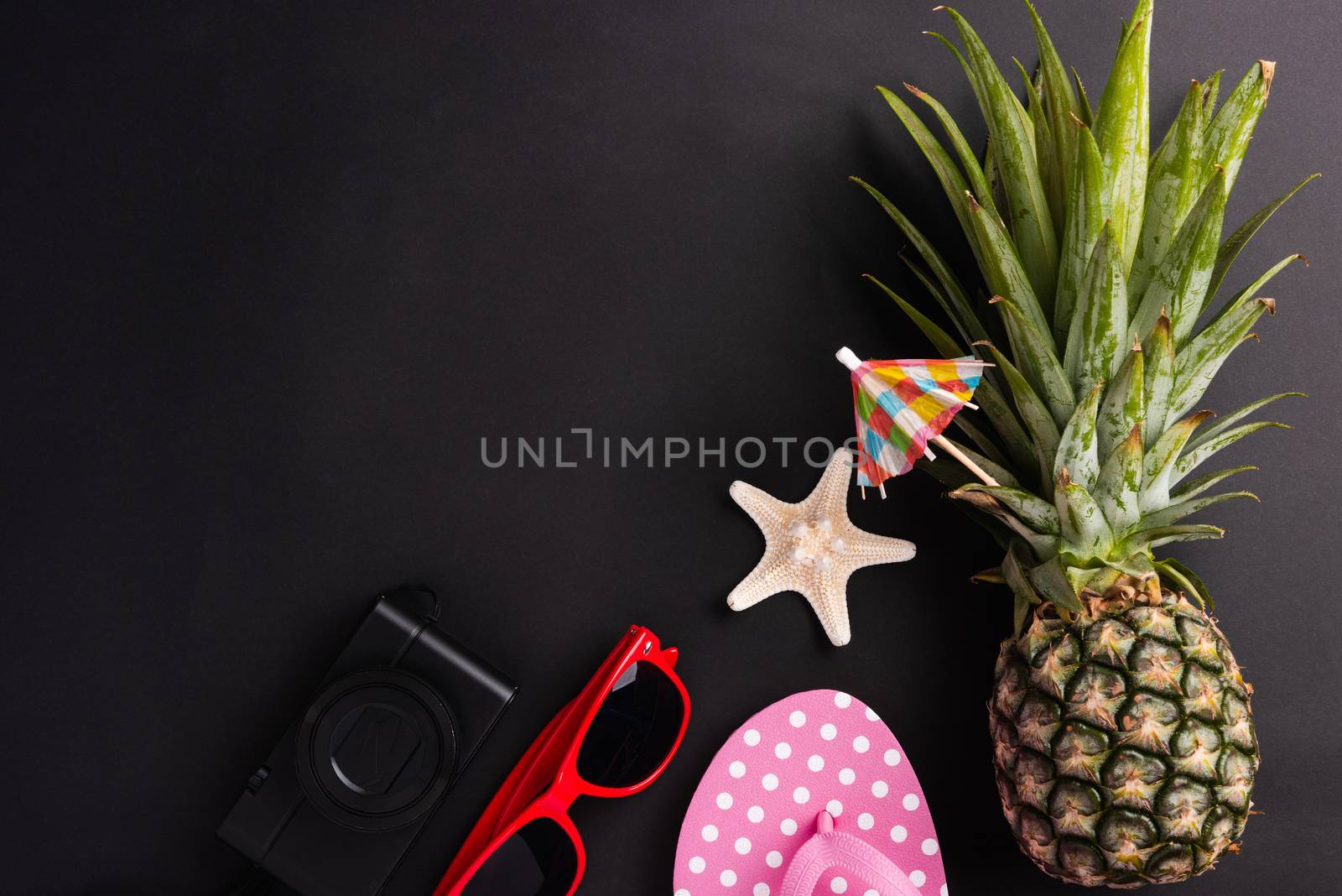 Celebrate Summer Pineapple Day Concept, Top view flat lay of funny fresh pineapple, sunglasses, starfish, slipper and camera, in studio isolated on blank background, Holiday summertime in tropical