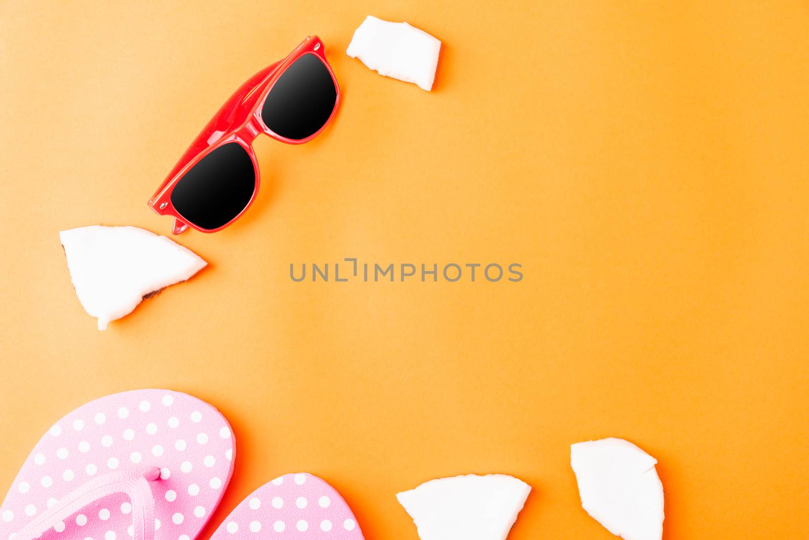 Happy coconuts day concept, fresh coconut, Sunglasses and Slippers, studio shot isolated on an orange background, Beach tropical fruit trip journey and spring-summer holiday