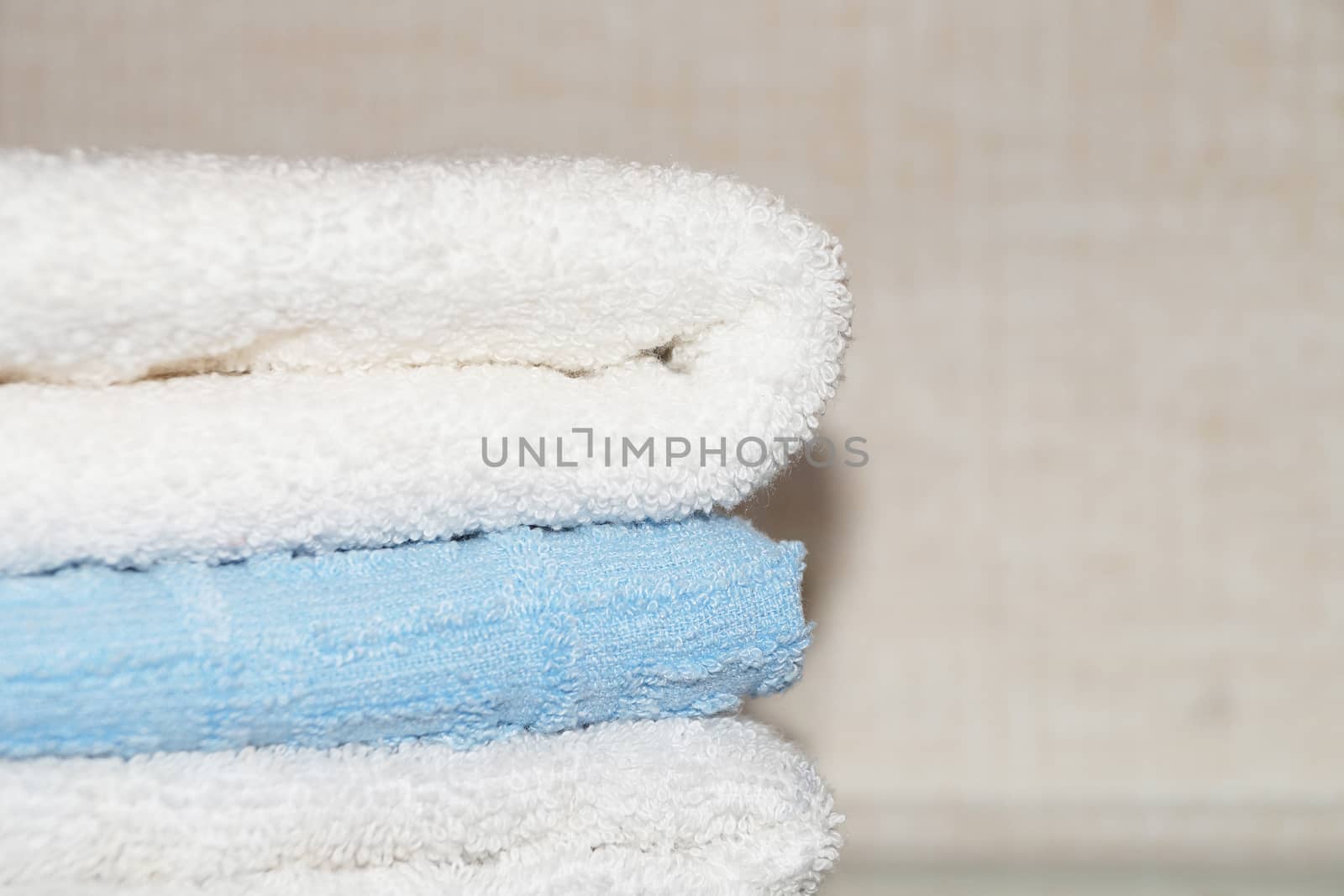 folded terry towels on a light background, copy space.