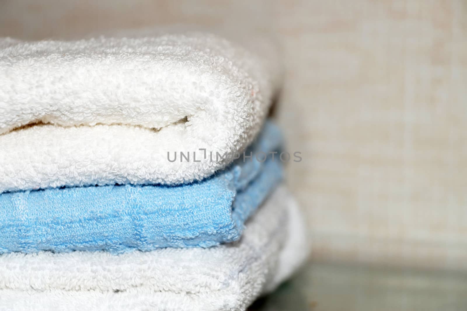 folded terry towels on a light background, copy space.