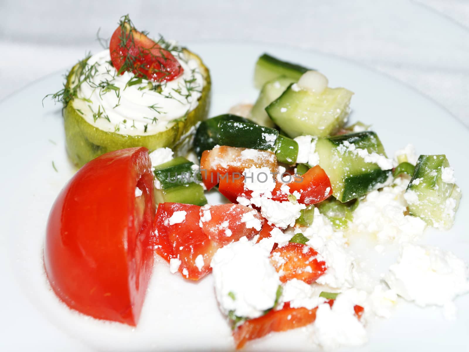 sstuffed with cheese peppers and vegetables on a white dish.