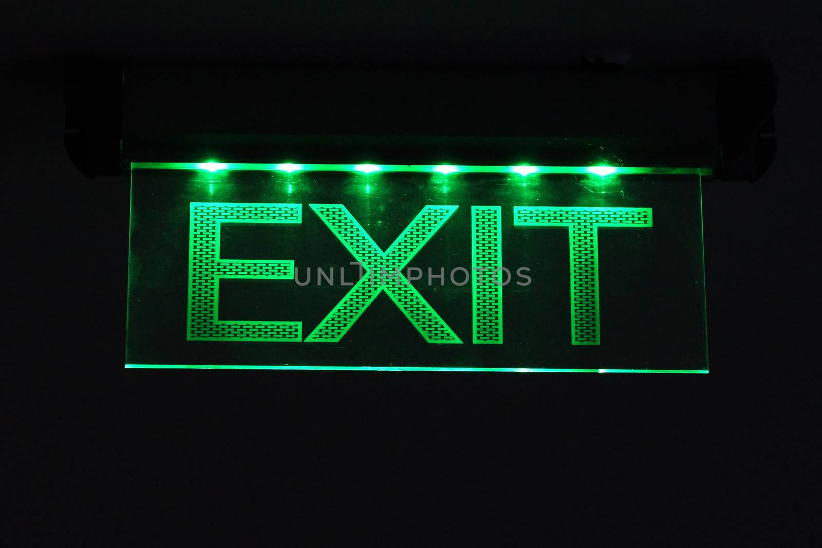 burning sign exit close up on black background by Annado