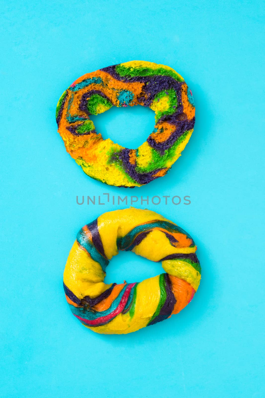 Colorful bagel on blue background by chandlervid85