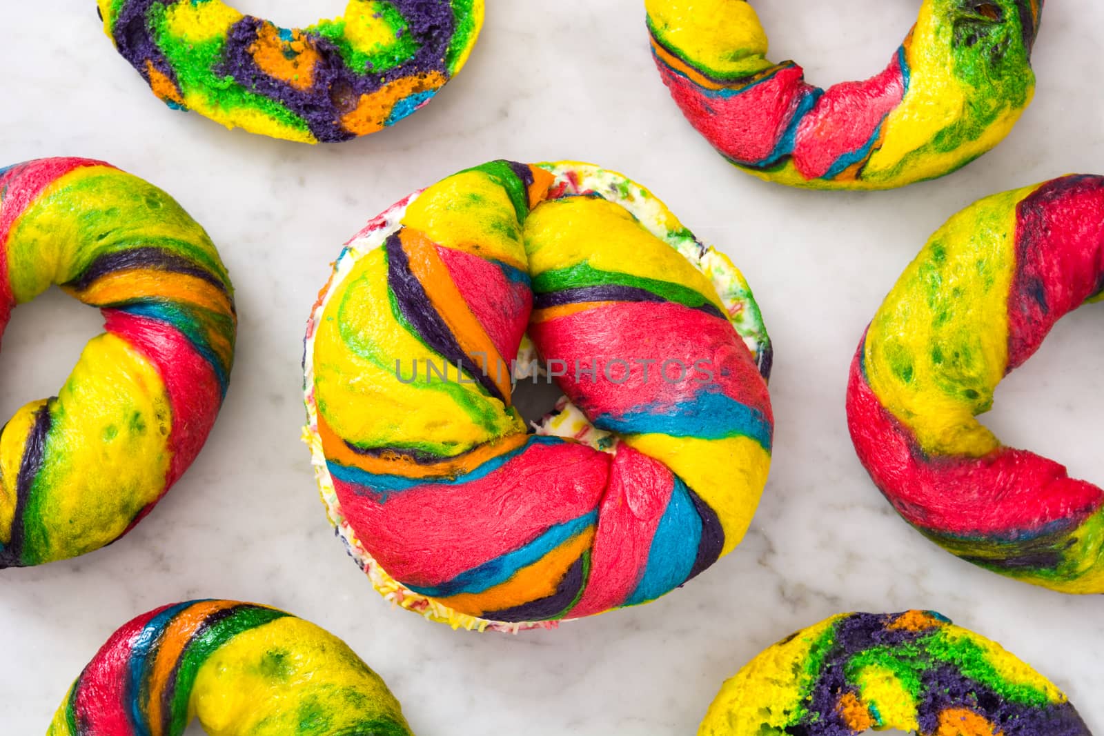 Colorful bagel with cheese and sprinkles on marble by chandlervid85