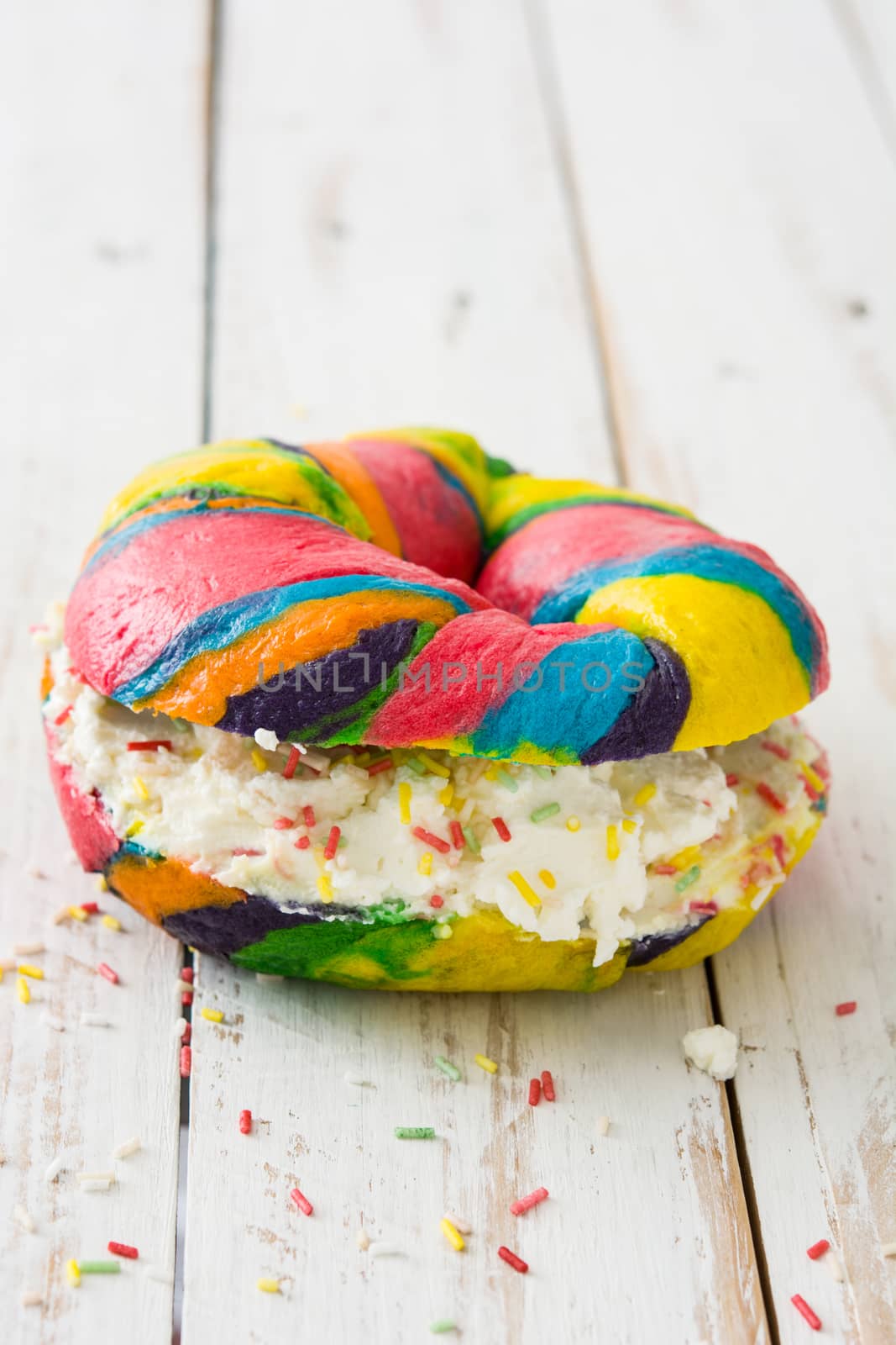 Colorful bagel with cheese and sprinkles