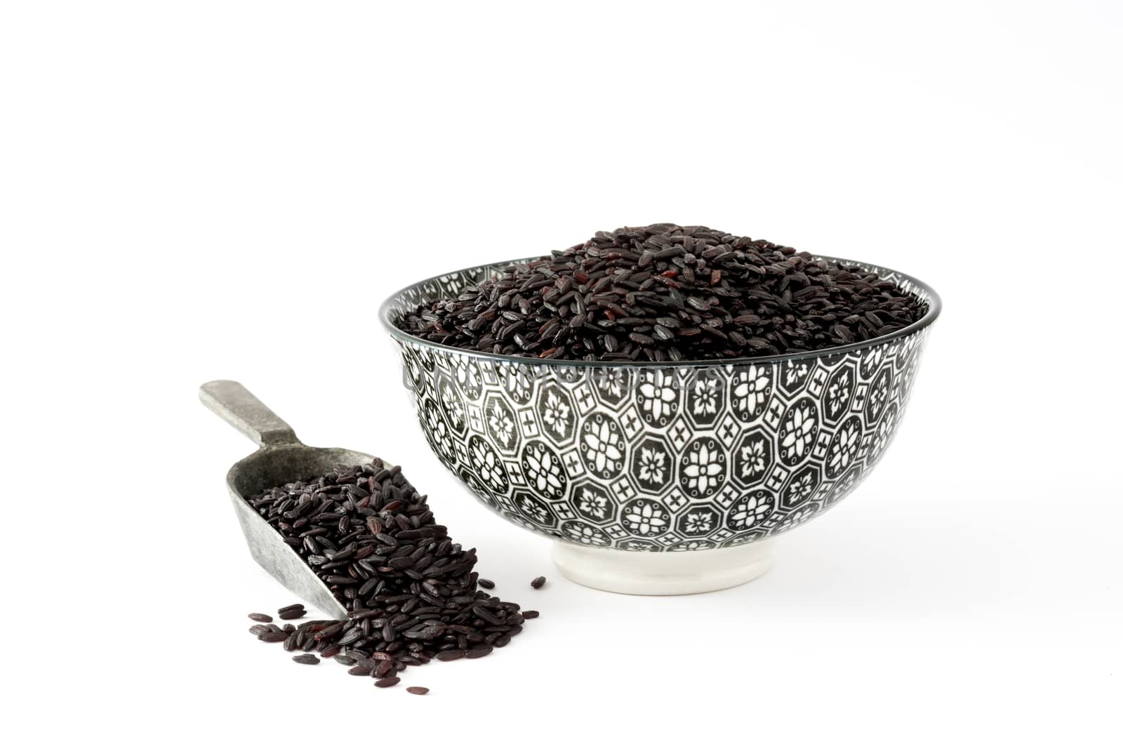 Raw black rice in a bowl isolated on white background by chandlervid85